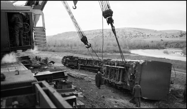 Second No. 3, an equipment special (deadheading Pullmans), derailed at 80 miles per hour on a 40 mile-per-hour curve, about a mile and a half east of Logan, Montana, on November 22, 1945, three days before this photo was taken. The locomotive is Class Z-8 4-6-6-4 no. 5132. The wrecker in the left foreground is a new 250-ton Z model, built by Industrial Brownhoist. It is believed to be Wrecker no. 45, but could possibly be no. 47, an identical model.