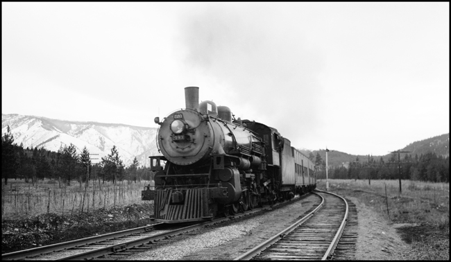 Passenger Extra 2193 East passes the west siding switch at Spring Gulch, Montana. Extra 5141 West is in the siding. The passenger extra is bringing troops home in the months after the end of World War II. Engine 2193 is a Class Q-4 4-6-2 built by Baldwin in October 1909. 