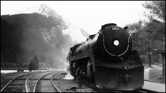 CPR Train No. 3 with CPR 5923 streamlined locomotive receiving attention at Field, BC.