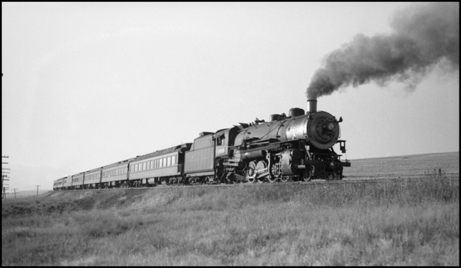 NP Train No. 1,with NP 1808 Class W-3 as the rear end helper with Engr. Dickman, with NP 2611, Class A, on the head end with Engr Melton, near DeSmet. Note: NP 1808 is pushing backward on Train No. 1.