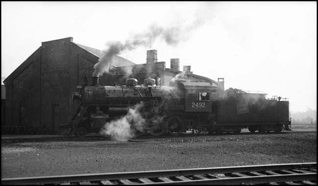 CN 2492 steam locomotive as seen at Niagara Falls, Ontario.  Too much steam in picture to see locomotive detail.