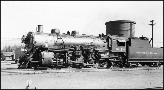 NP 1811, Class W-3 stopped just west of the automobile Underpass at Livingston.  Sawyers Grocery store building in background just beyond front of engine.
