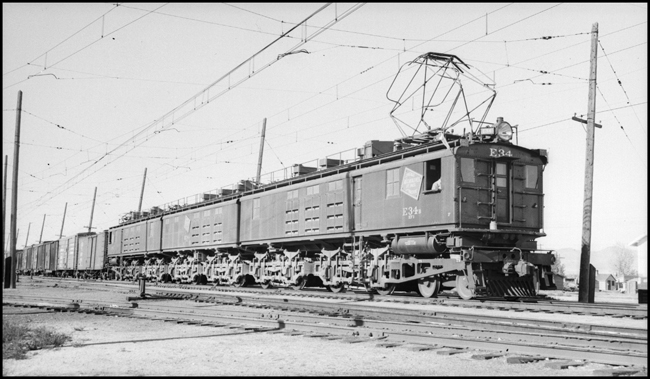 MILW freight train pulled by electric locomotive MILW E-34 at Three Forks, MT