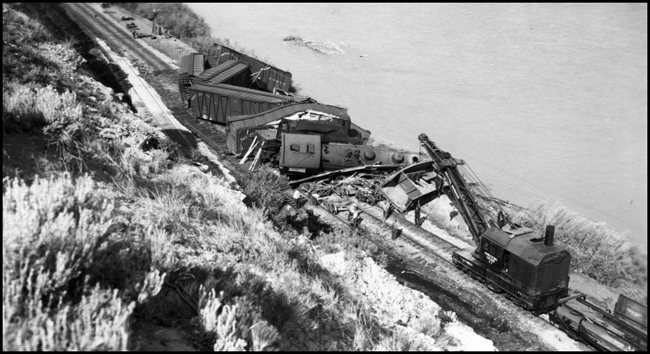 View from high above the accident involving NP train X1730E which collided with a work train near Lockwood, east of Billings.  Wrecker is beginning to pick up damage in the photograph. There were no fatalities but several were injured.  NP 1730, Class W-3 was extensively damaged. 