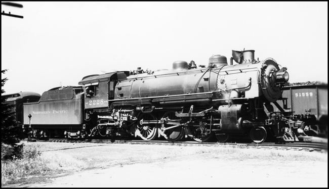 NP 2228, Class Q-5 locomotive on passenger run in Bozeman at east end of depot.