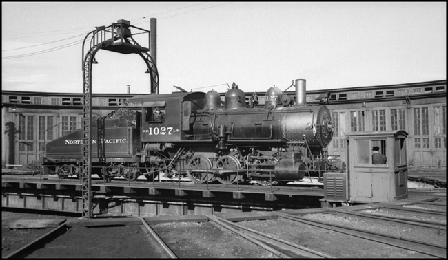 An elderly switcher, Class L-7, rides the turntable at the big roundhouse at Helena.  With a little more visibility it could have been a poster engine for Trains Magazine which favored the number 1027.