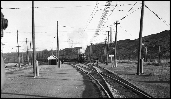 What's this steam locomotive doing in electric territory?  The Butte, Anaconda & Pacific kept several steam engines on the payroll, some including this one, until 1953, to handle switching on unelectrified spurs and one branch line.  