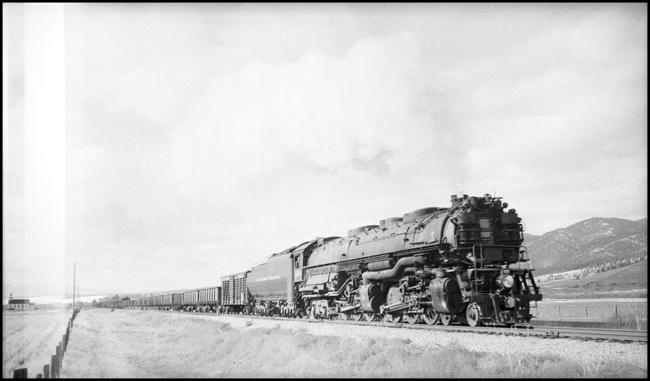 One cattle car and an endless line of 40 foot gondolas going back to the Rosebud mine in eastern Montana, does not make up the normal train for a Z-6 Challenger.  But the war years can find any kind of power on any kind of train. 