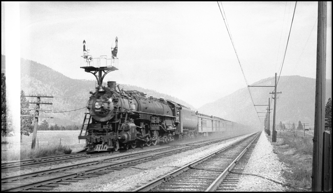 NP Train No. 1, with NP 2667, Class A-3, between Bonner and Missoula, MT, paralleling MILW's electric line.