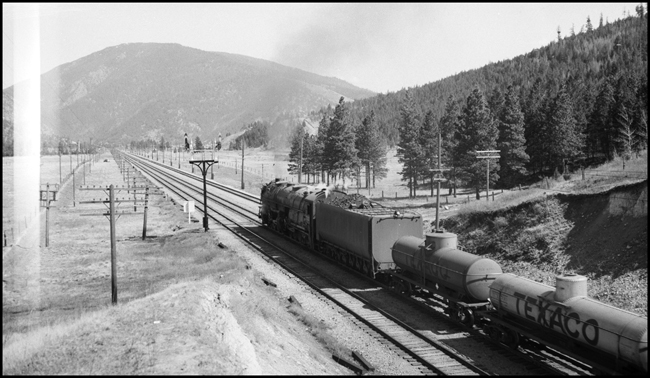 NP X5121E with NP 5121, Class Z-7 pulling two tank cars immediately behind locomotive between Bonner and Missoula