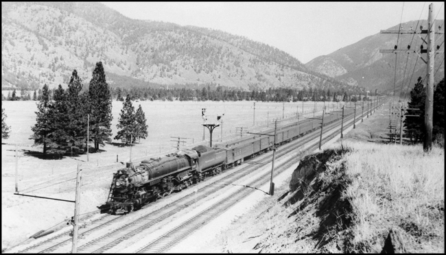 NP Train No. 1, with NP 2667, Class A-3, between Bonner and Missoula, MT, paralleling MILW's electric line.