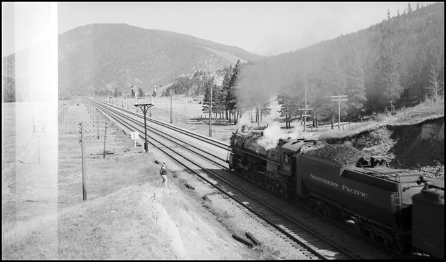 NP Train No. 2 with NP 2666, Class A-3, between Bonner and Missoula, paralleling MILW electric line.