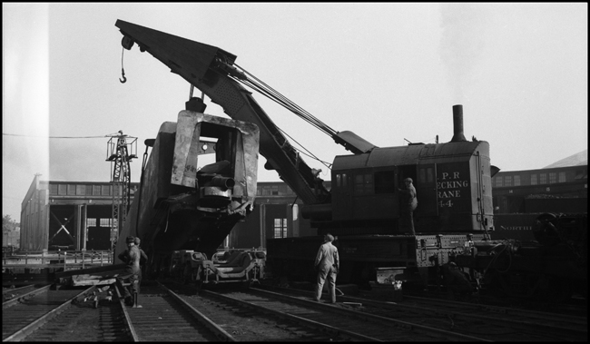 Opps,  tender of NP 5126 being lifted out of Turntable pit at Missoula roundhouse by NP Wrecker 44