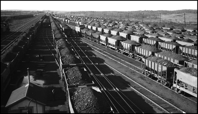Duluth Minnesota and Iron Range RR Yard in Proctor, MN with lots of loaded ore cars full of iron ore.