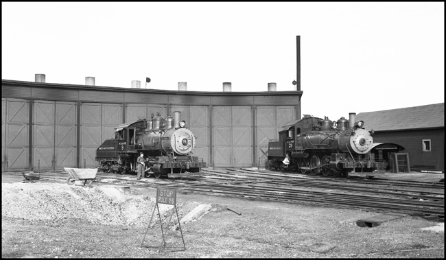 Manitoba Dakota & Western locomotives 9 and 20 in front of roundhouse at International Falls, MN