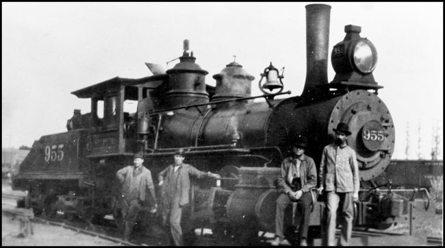 NP 955, Class K-1 surrounded by crew posing for camera in front of locomotive.