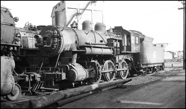 This locomotive is missing its drive rod and is probably headed for the scrapper.  It is an early 1900s design and has been superceded by newer and more powerful locomotives.   It was probably needed for the war effort, but is so no longer.