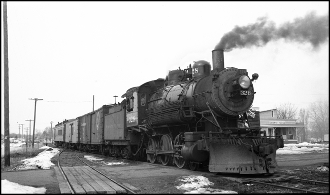 This is a mixed train on the Taylors Falls branch line.  The class S-10 328 was part of a group of locomotives built for another railroad, and purchased by NP when that railroad defaulted on the order.  The 328 was saved after dieselization, and for many years pulled excursion trains in northern Minnesota.  In 2006 it may be found in the Jackson Street Roundhouse in Minneapolis awaiting rebuilding.