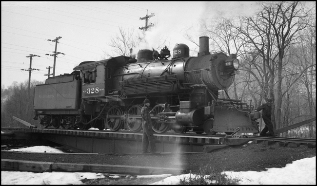 The class S-10 328 was part of a group of locomotives built for another railroad, and purchased by NP when that railroad defaulted on the order.  The 328 was saved after dieselization, and for many years pulled excursion trains in northern Minnesota.  In 2006 it may be found in the Jackson Street Roundhouse in Minneapolis awaiting rebuilding.  It has just pulled a mixed train to the end of the Taylors Falls branch line, and is being turned on the 