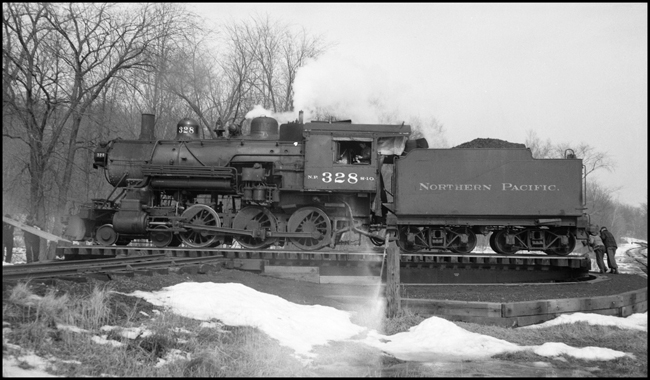 The class S-10 328 was part of a group of locomotives built for another railroad, and purchased by NP when that railroad defaulted on the order.  The 328 was saved after dieselization, and for many years pulled excursion trains in northern Minnesota.  In 2006 it may be found in the Jackson Street Roundhouse in Minneapolis awaiting rebuilding.  It has just pulled a mixed train to the end of the Taylors Falls branch line, and after having been turned on the 