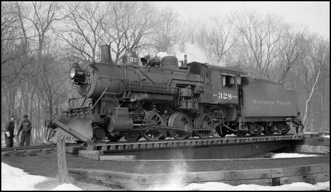 The class S-10 328 was part of a group of locomotives built for another railroad, and purchased by NP when that railroad defaulted on the order.  The 328 was saved after dieselization, and for many years pulled excursion trains in northern Minnesota.  In 2006 it may be found in the Jackson Street Roundhouse in Minneapolis awaiting rebuilding.  It has just pulled a mixed train to the end of the Taylors Falls branch line, and after having been turned on the 