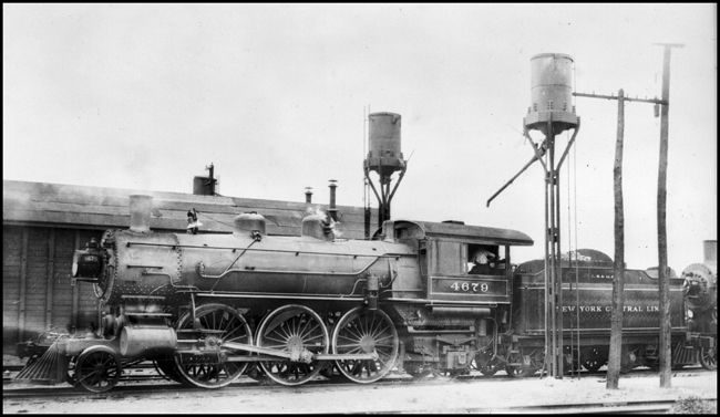Note the very high drivers on this 2-6-2 locomotive.  It is probably fairly new, but still has not been fitted with electricity.