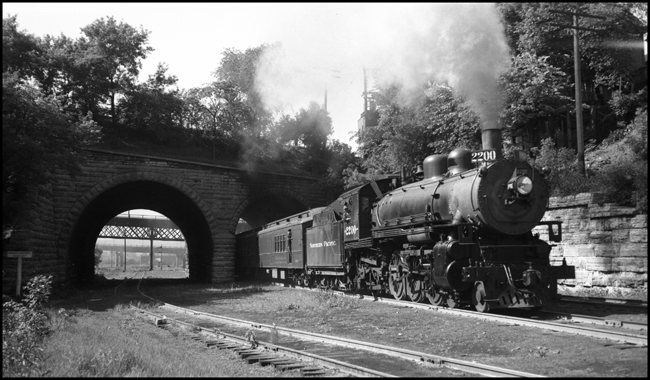 Class Q-4 2200, a 1907 Baldwin 4-6-2, on train 62 passing under the SOO line.  Train 62 runs from Minneapolis to Duluth, via St Paul and Superior.  In a short while it will pass by the Mississippi St roundhouse.