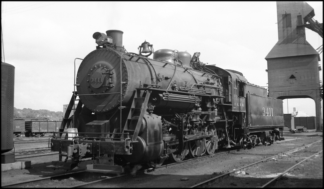 Illinois Central 0-8-0 3411 in Council Bluffs yard, coal tower in background.