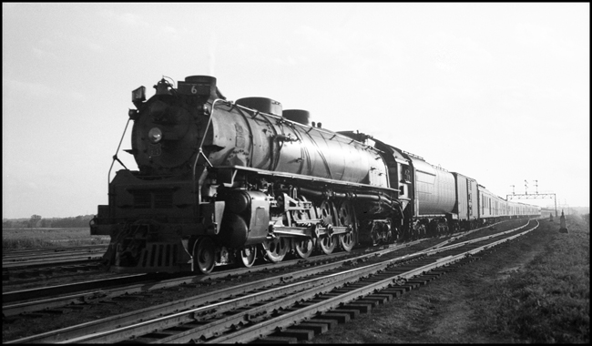 Union Pacific train 6 enters Council Bluffs IA, with engine 812. Signal bridge in back.