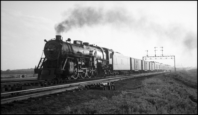 Rock Island 4-8-2 4045 on eastbound passenger train, Council Bluffs, IA. Signal bridge in back.