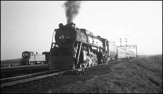 Milwaukee Road eastbound Midwest Hiawatha entering Council Bluffs yard with engine 260, four cars.