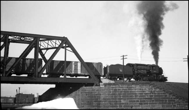 CNJ engine 682 and freight train crossing truss bridge, Jersey City.