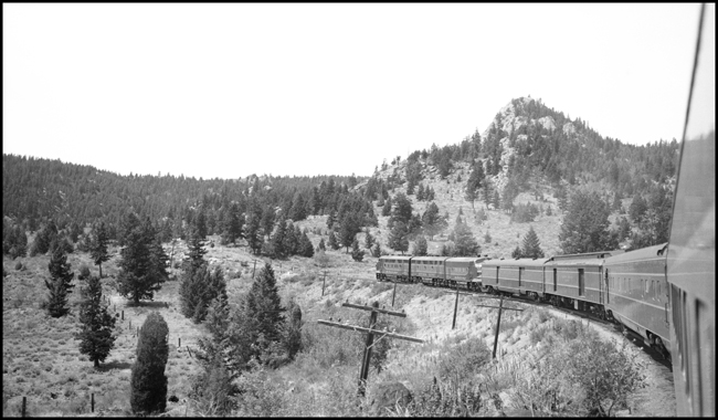 Looking forward from vestibule aboard NP No. 1, westbound NCL, in mountains, Welch, MT.