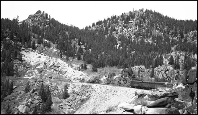 Looking forward from vestibule aboard NP No. 1, westbound NCL, in rugged terrain, Highview, MT.