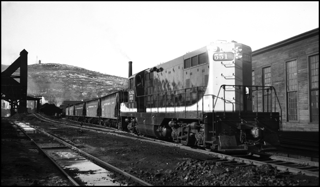 NP 551, EMD GP-7 road switcher moving freight train in Duluth switch yards.
