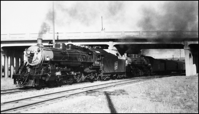SOO 734 and 2708 doubleheading on Passenger run leaving Minneapolis, about in the area of SOO's Shoreham Yards.