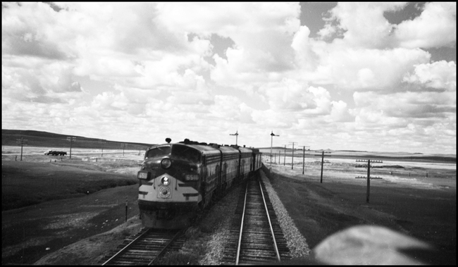A view from Train No.3 of east bound Train No. 4, the Alaskan, at Eagle Nest, North Dakota.  No.4 is being pulled by NP F-7A 6510.