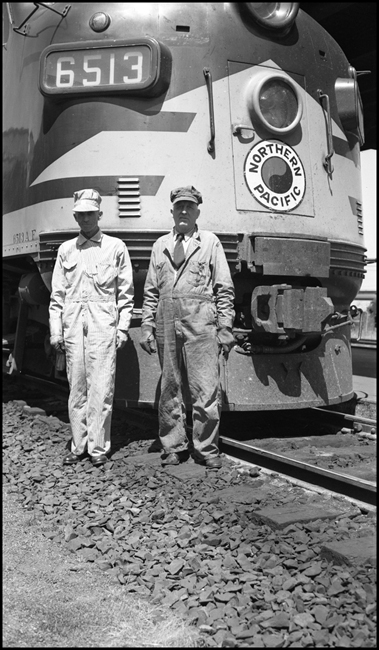 Engineer E.J. Fuhr and Fireman W. H. Berg standing proudly before their steed NP 6513A at Tacoma, WA.