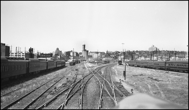 NP 407 is pulling into the maze of the yard throat at Seattle, WA.  Passenger coaches in Pine Tree scheme and pullman green livery.