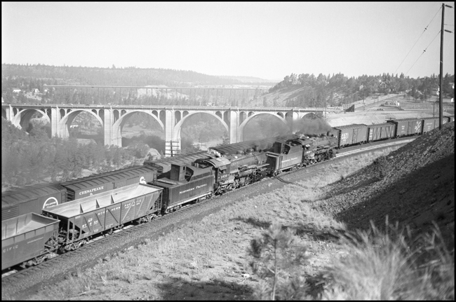 On this summer day in July 1951 near Spokane, this double headed train behind sisters 1810 and 1816.  These W-3 class 2-8-2 heavy Mikados were the most populous type on the roster.  They were well liked by their crews, performed well for the NP, but were no match for diesel.  Large numbers were scrapped between 1955 and 1959.