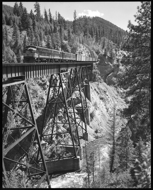 NP X5407 East freight train crossing on Fish Creek trestle between Cyr Rivulet, Montana.
