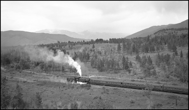 NP 1382, a 4-6-0 10-Wheeler Class S-4, is at the rear of the east bound North Coast Limited as a helper near Schley, Montana.