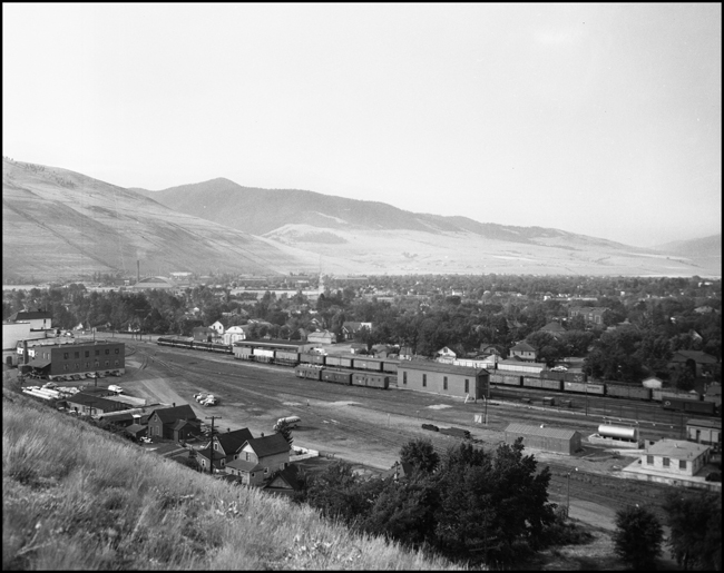 NP extra east bound freight leavin Missoula, MT. with yard panorama.