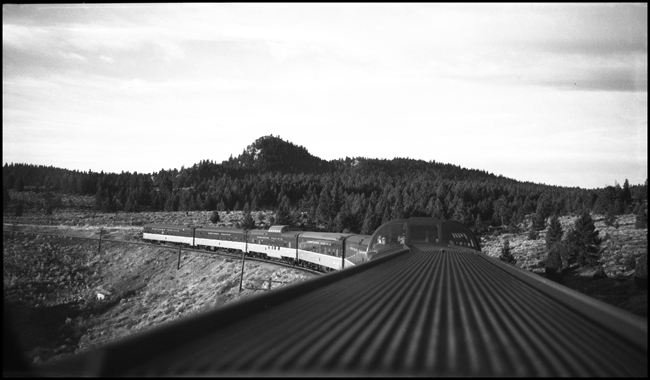 View of Spire Rock and the rear of Train No. 26 from a dome car on the way east from Butte, MT
