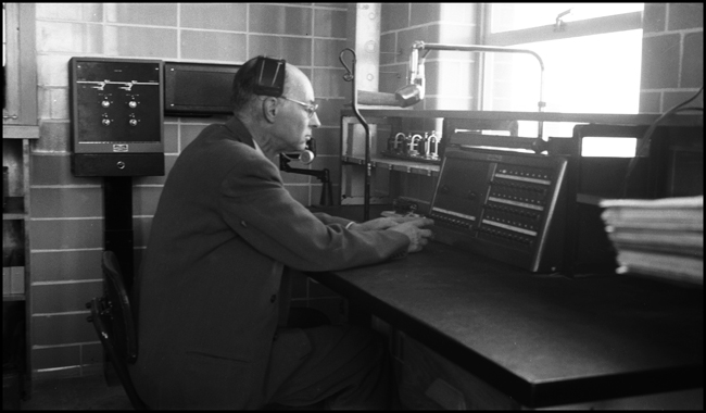 F A Mackenroth, Asst. Supt of Communications at the communications desk in the Pasco Hump Tower office building. 