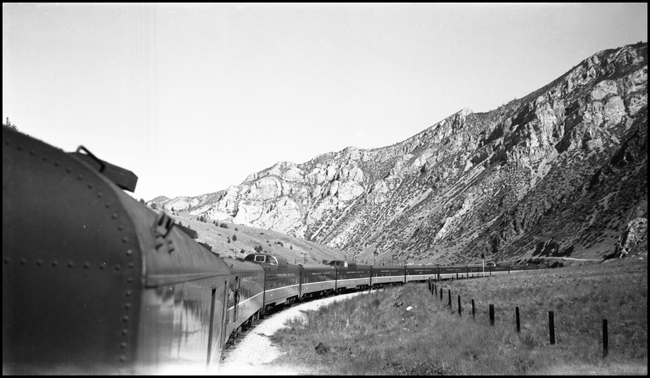 Mountain view and left side of train as seen from onboard Train No. 26, near Lime Spur by Pipestone, MT.