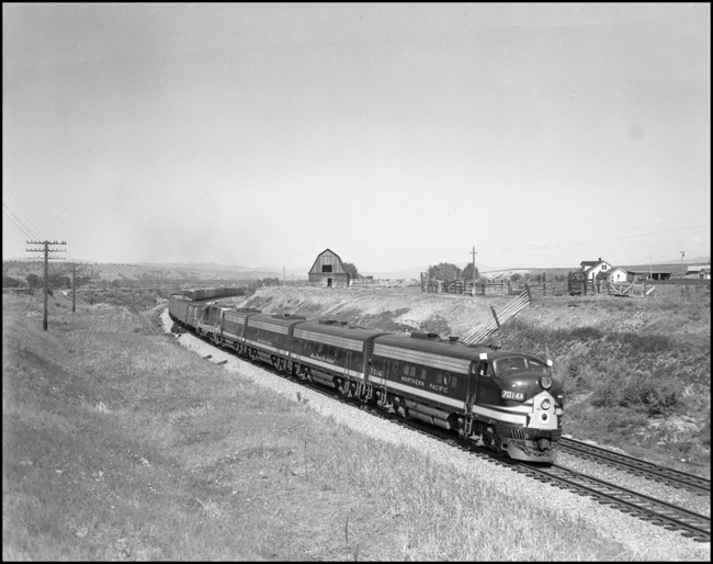 NP 7014, EMD F-9A and an EMD GP pull an extra freight train eastbound at Jens, MT