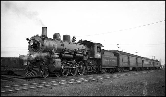 NP 2218, 4-6-2 Class Q-4 pulling train No. 14, the Manitoba Limited, at Portage Jct. Manitoba.
