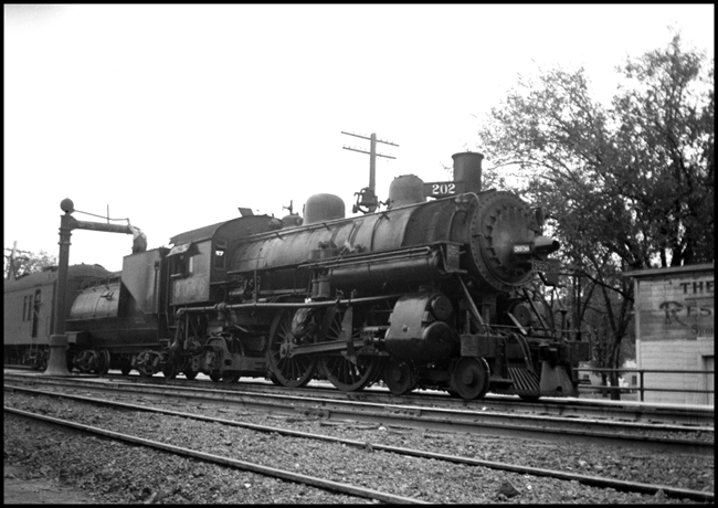 SP 3036 at the water column with a passenger train at Marysville, California.