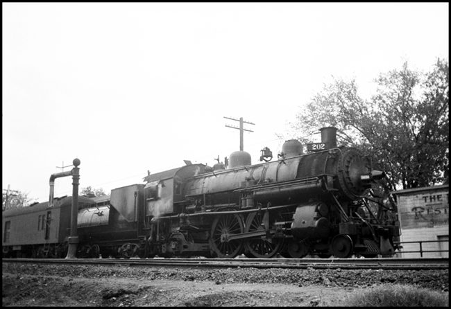 SP 3036, 4-4-2 steam locomotive, with a baggage-mail car attached so this is probably in a passenger train at Marysville, CA.
